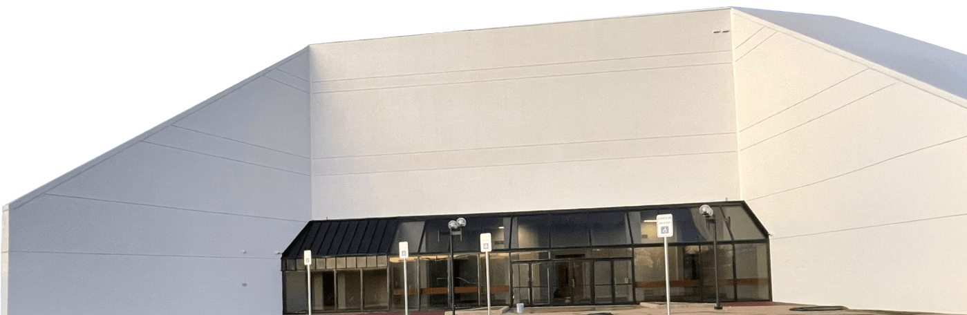Aerial lift worker painting white building exterior